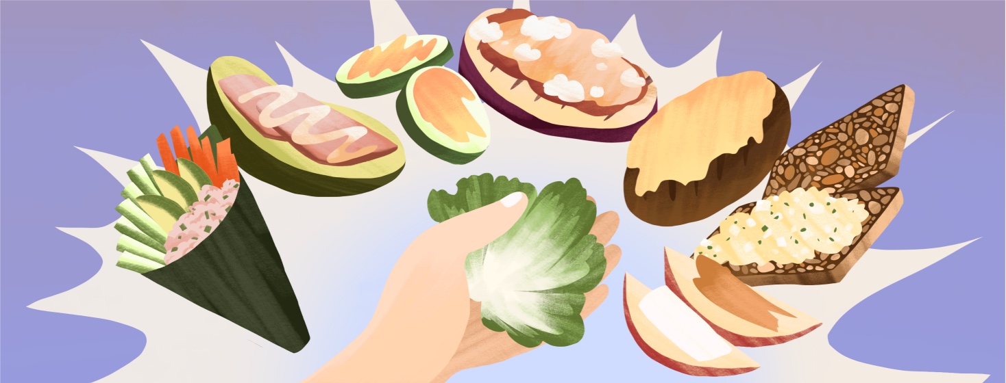 A hand holds a lettuce leaf, surrounded by other low-carb bread substitutions for wraps and sandwiches like seaweed sheets, pickles, cucumbers, grilled eggplant, grilled mushroom, seed bread and apple slices